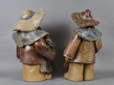two figurines of a man and a woman wearing hats