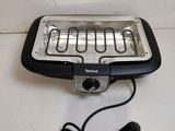 a close up of a toaster on a table with a cord