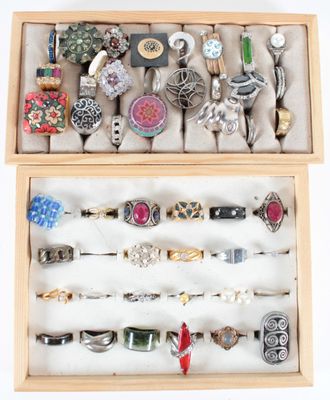 a wooden box filled with assorted rings and bracelets