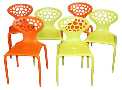 several chairs are lined up in a row on a white surface