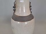 a white vase with a brown stripe on it