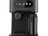 a black coffee machine sitting on top of a white surface