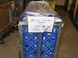 a blue cart with a sign on it in a warehouse
