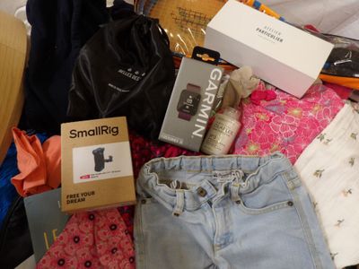 a pile of clothes and other items that are on a bed
