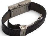 a watch on a black leather strap with a silver buckle