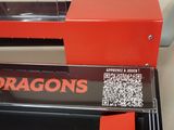 a close up of a red machine with a qr code on it