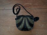 a small purse that is sitting on a wooden floor