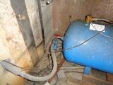 a blue tank with a hose attached to it