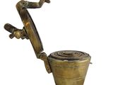 brass toilet with a handle and a hose attached to it