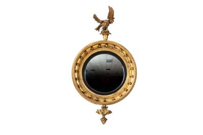 a gold clock with an eagle on the top of it