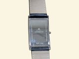 a watch that is sitting on top of a leather strap