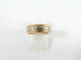 gros plan d'une bague en or sur une surface blanche