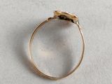 an image of a gold ring on a white surface