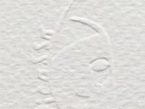 a close up of a piece of white paper with a drawing of a woman ' s face