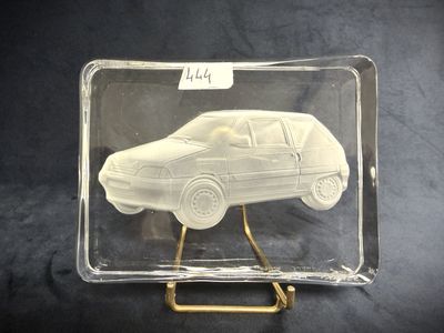 a clear box with a car in it on a stand