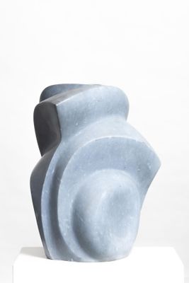 a blue sculpture on a white pedestal on a white surface