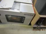 a box that is sitting on the floor next to a microwave