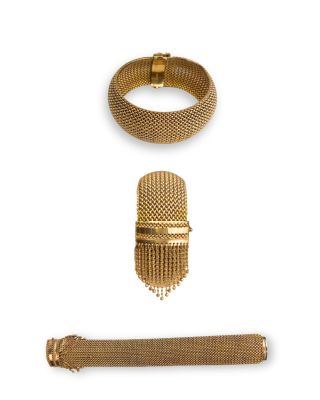 an assortment of gold jewelry including a bracelet, ring, and bracelet