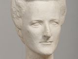 plaster bust of a woman ' s head on a table