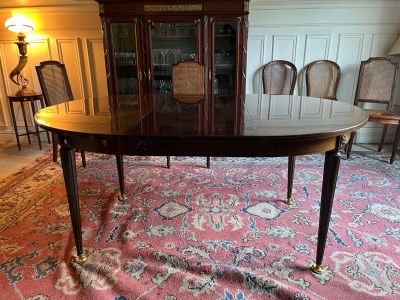 a large dining table with a glass top in the middle of a room