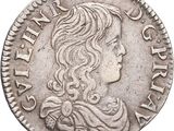 a silver coin with a woman ' s head on it