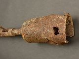 an old metal object with a hole in the middle of it