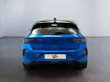 the rear end of a blue car in a white room