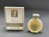 an image of a small bottle of perfume next to a box