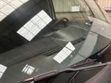a car that has a sticker on it ' s windshield