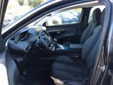 the interior of a car with the door open and the driver ' s seat down