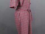 a red and white checkered dress on a mannequin mannequin