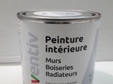 a can of paint sitting on a white table