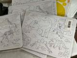 four pieces of coloring paper sitting on a table