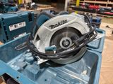 a circular saw sitting on top of a blue box