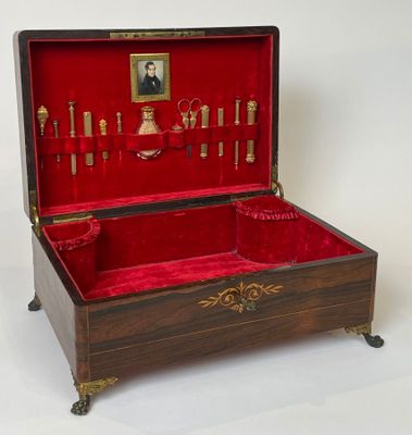 a wooden box with a red velvet lining and gold trim