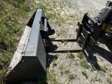 a picture of a skid steer and a skid steer on the side of the road