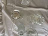 a white sheet that has a bunch of glass items on it