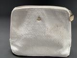 a close up of a white purse on a table