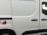 the side of a white van parked in a parking lot