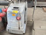 a machine that is sitting on the ground next to some barrels