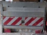 a red and white truck with a red and white stripe on the back