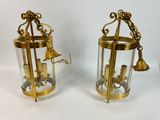 pair of antique brass and glass lanterns with bells on them