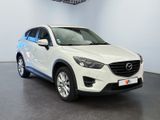 a white mazda cx - 5 parked in a showroom
