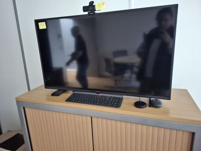 a flat screen tv sitting on top of a wooden cabinet
