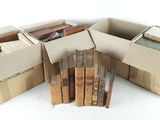 boxes of books are stacked on top of each other on a white surface