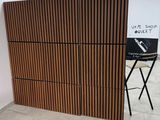 a wooden paneled wall in a room with a chair