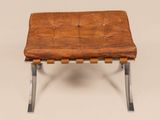 an image of a brown leather bench with metal legs