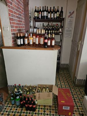 bottles of wine are lined up on a tiled floor in a room