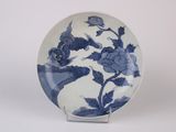 a blue and white plate with a flower design on it