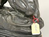 a statue of a dog with a tag on it ' s neck